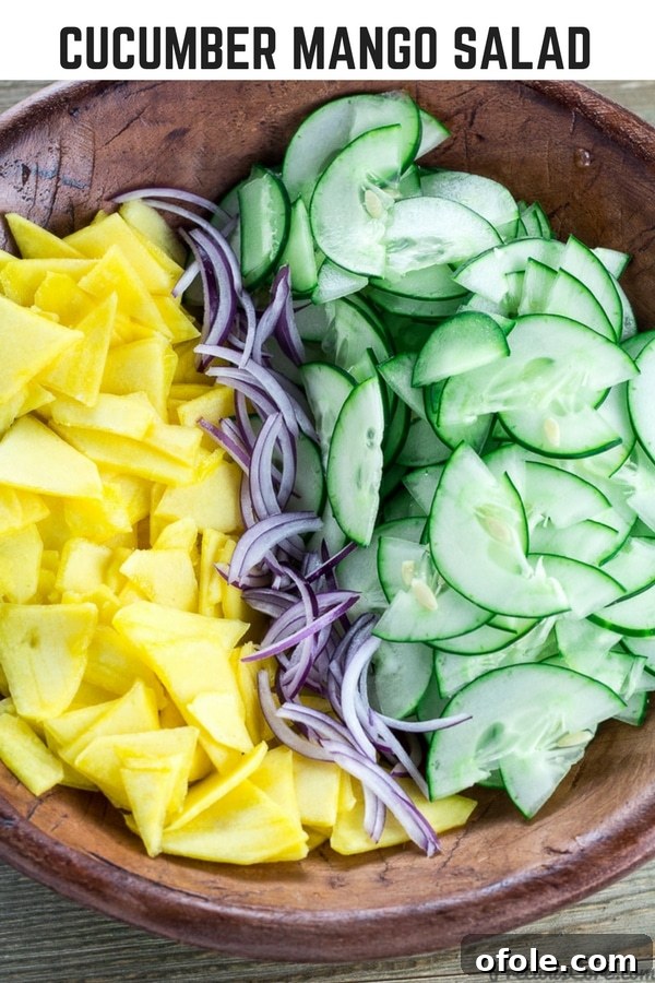 Vibrant Mango Cucumber Refresh 8 Bowl of unmixed salad with text "Cucumber Mango Salad." This image is perfect for pinning to your recipe boards.