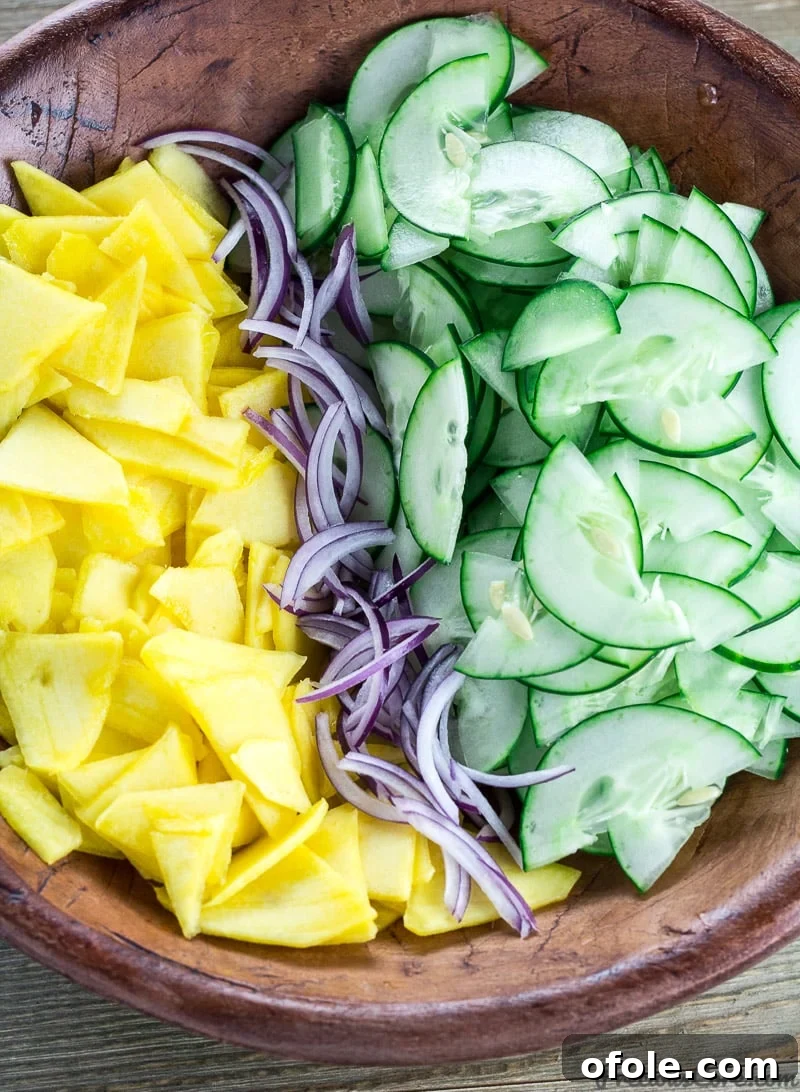Vibrant Mango Cucumber Refresh 3 Cucumber Mango Salad in a bowl, ready to be served at a gathering.