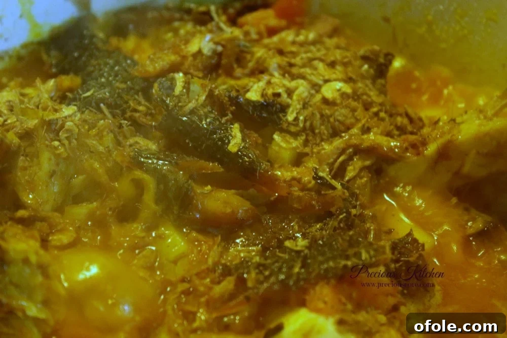 Yam porridge ingredients simmering in a pot