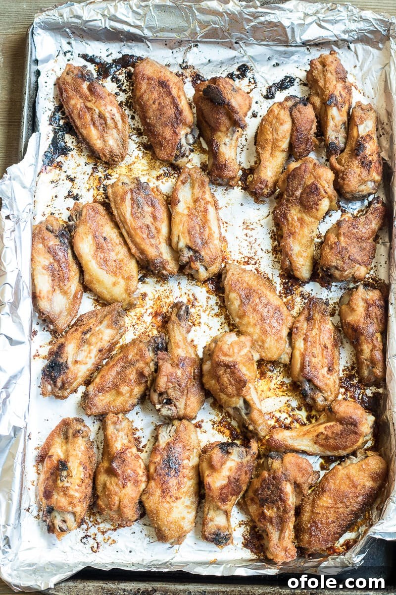 Freshly oven-grilled chicken wings, golden-brown and glistening, straight out of the oven.