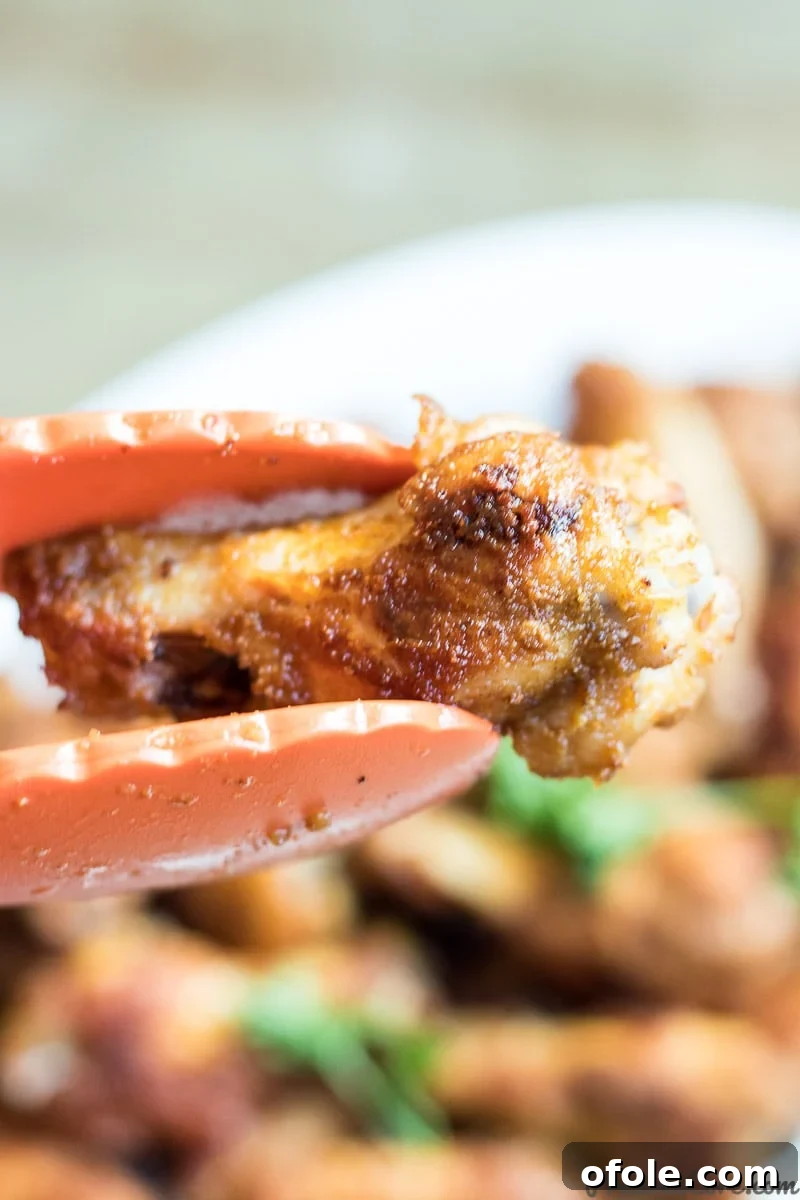Close-up of epic oven-grilled chicken wings, showcasing the crispy skin and rich seasoning.