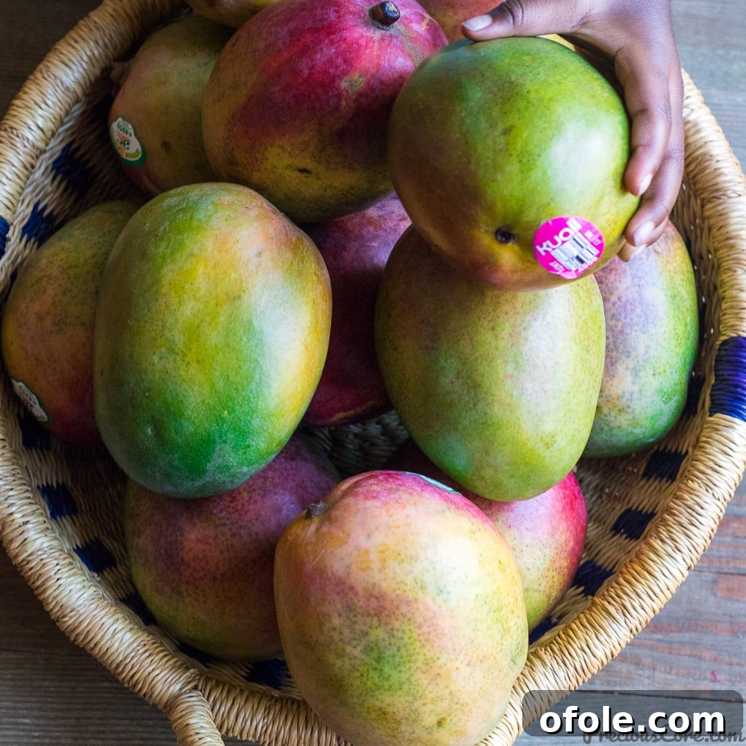 Golden Mango Elixir 4 A pile of fresh, ripe mangoes ready for juicing.
