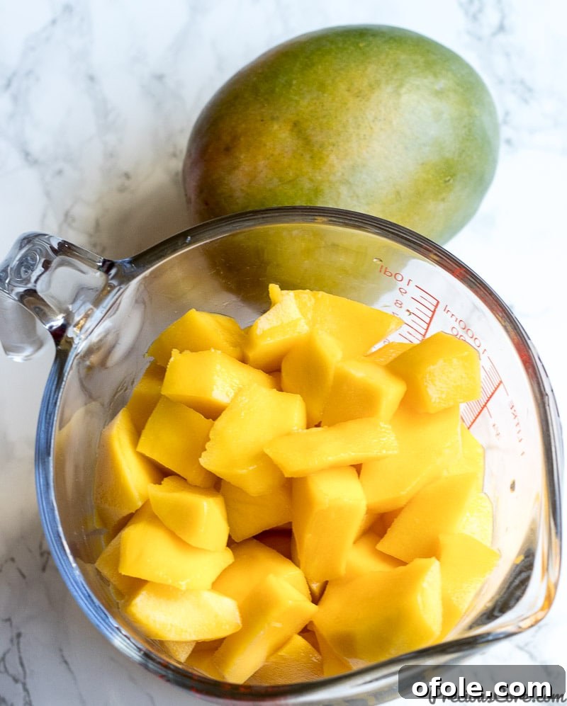 Golden Mango Elixir 6 A bowl of peeled and diced mangoes, ready for blending into juice.