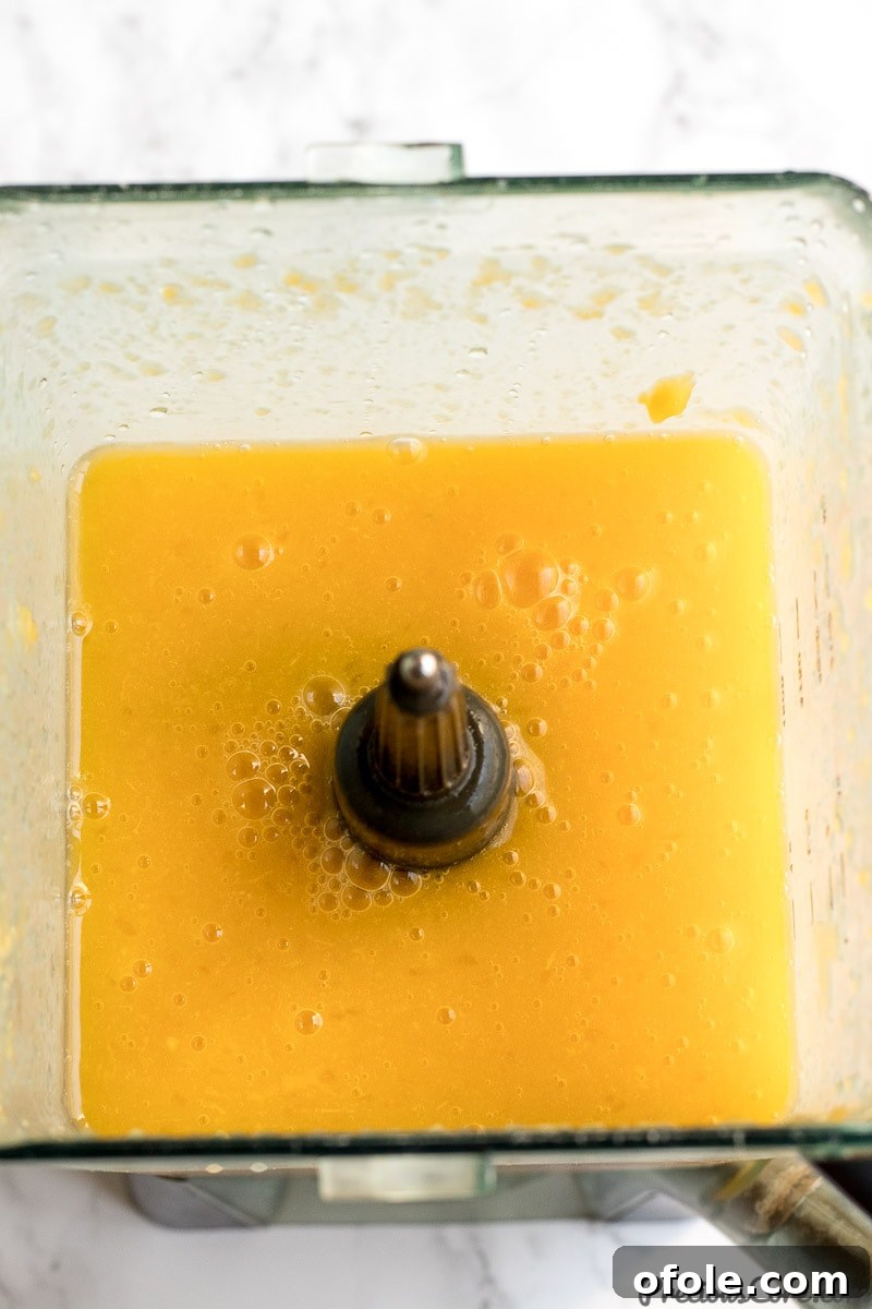 Golden Mango Elixir 8 Freshly blended mango juice in a blender jar.
