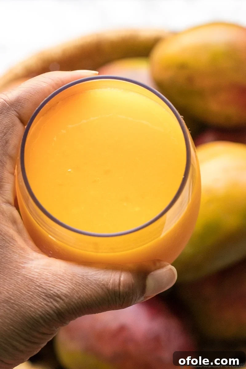 Golden Mango Elixir 9 A glass of homemade mango juice, ready to be enjoyed.