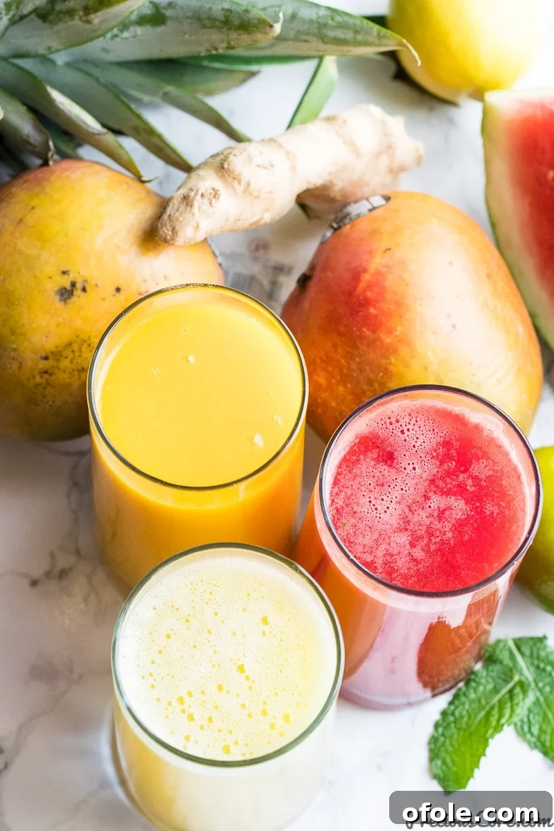 Fuel Your Day: 3 Healthy Juice Blends 6 Healthy Juice Recipes - Homemade - Variety of fresh fruits and vegetables around colorful juice glasses.