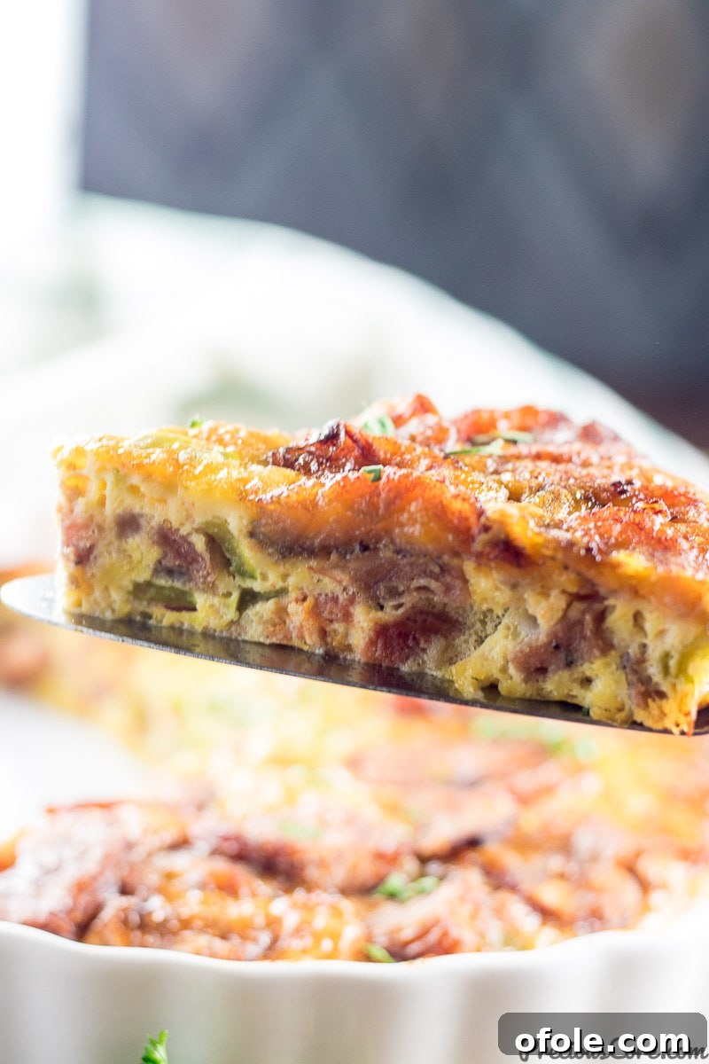 Golden Plantain Bake 3 A slice of plantain frittata showing layers of egg, vegetables, and plantain