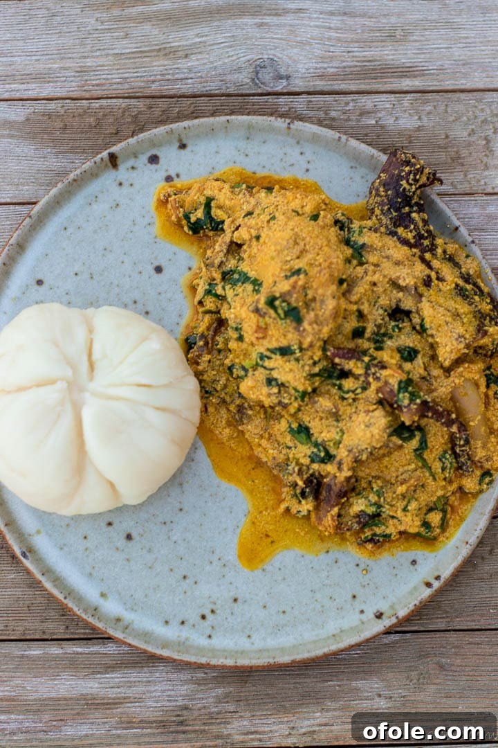 Egusi: Africa's Signature Stew 6 Egusi soup and pounded yam on a plate, a classic Nigerian meal.