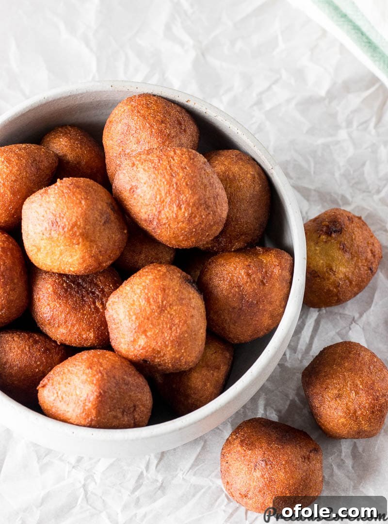 Golden African Banana Fritters 4 Accra Banana fritters arranged neatly on a serving platter, ready to be enjoyed.