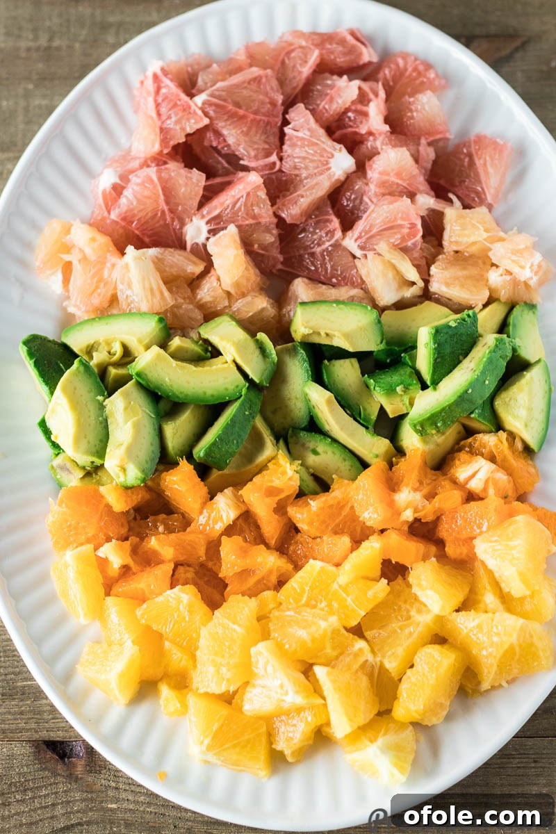 A close-up shot of Citrus Salad with Avocado, highlighting the glossy texture of the dressing and fresh herbs.