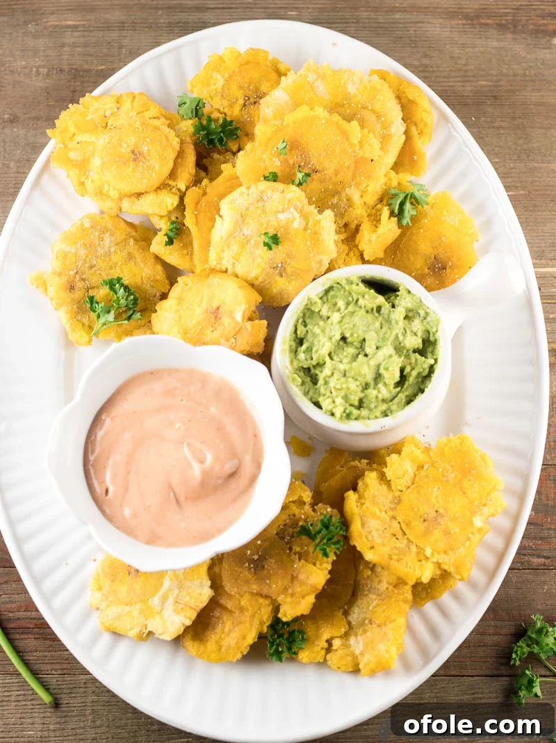 Golden Crispy Tostones The Ultimate Twice-Fried Plantain Recipe 2 Tray of tostones with dips.