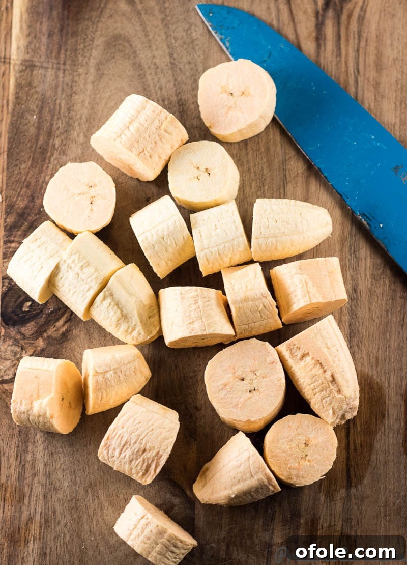 Golden Crispy Tostones The Ultimate Twice-Fried Plantain Recipe 5 Knife with sliced plantains.