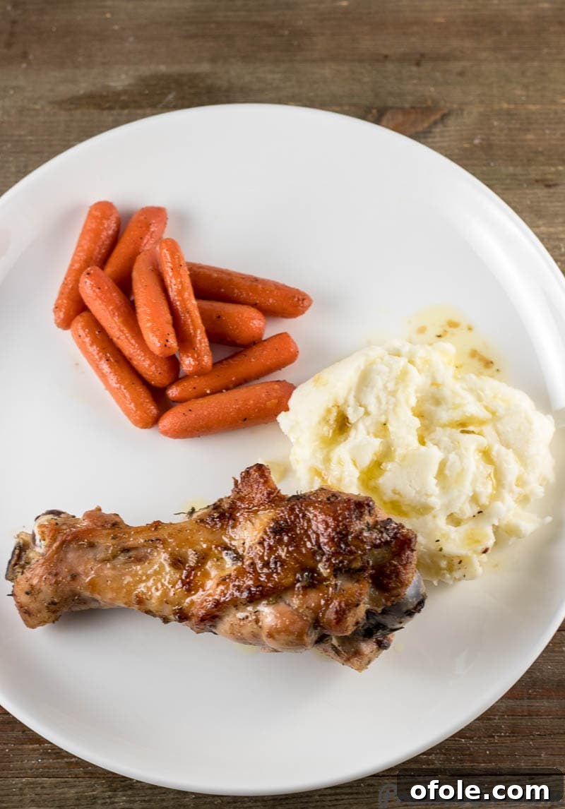 Golden Baked Turkey Wings 8 A serving of beautifully baked turkey wings, accompanied by creamy mashed potatoes and vibrant sautéed carrots.