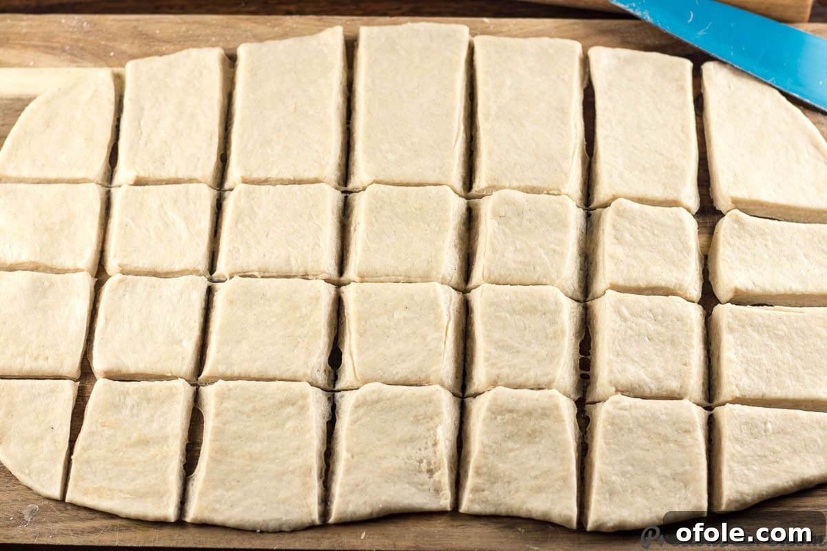 Mandazi East African Fried Pastry 8 Mandazi dough cut into pieces.