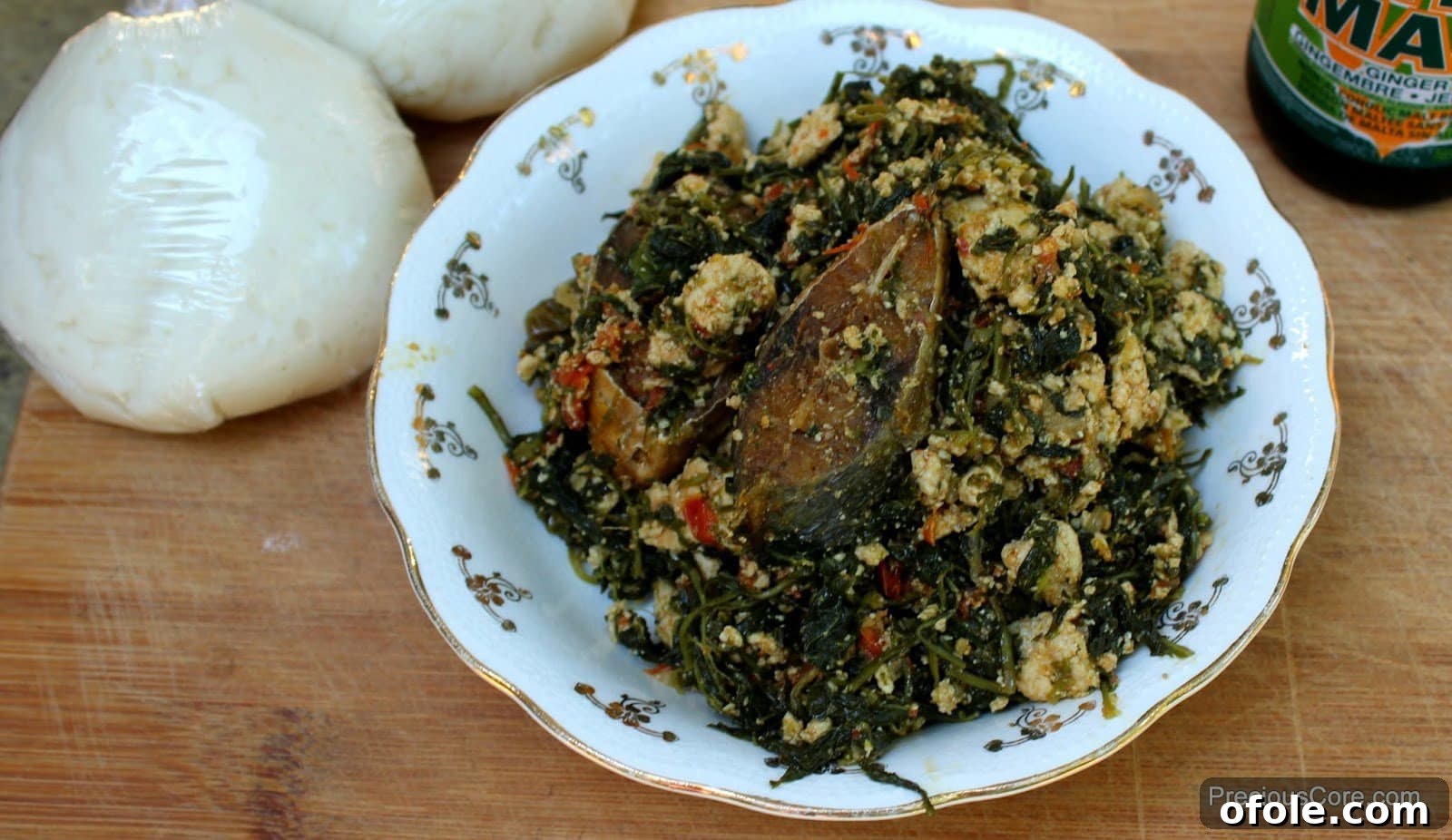 Njama Njama with Egusi in a white bowl, a traditional Cameroonian dish.