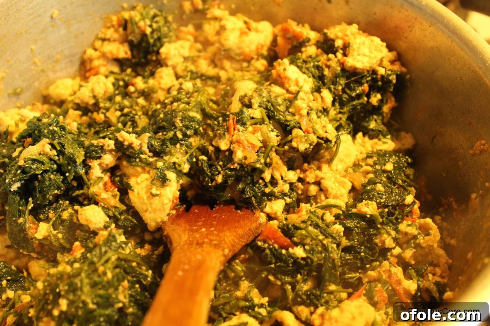 Cameroonian Njama Njama huckleberry stew in a pot, ready to serve.
