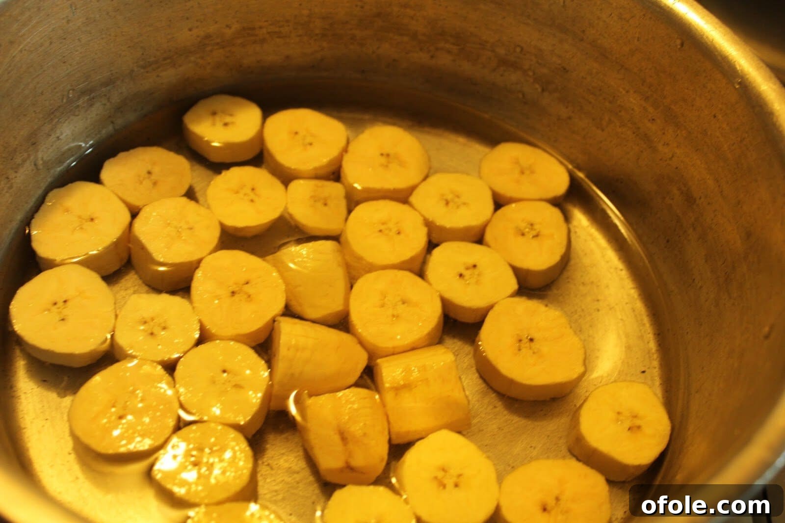 Authentic Sese Plantain Porridge 4 Plantains, palm oil, onions, and crayfish in a pot before cooking