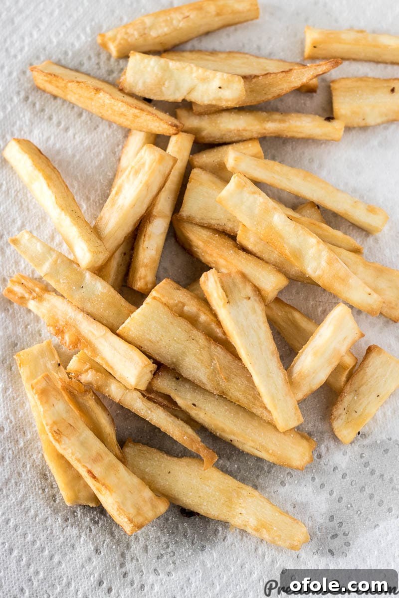 Irresistibly Crispy Yuca Fries 2 Super crispy Yuca Fries on a paper towel, ready to be enjoyed.