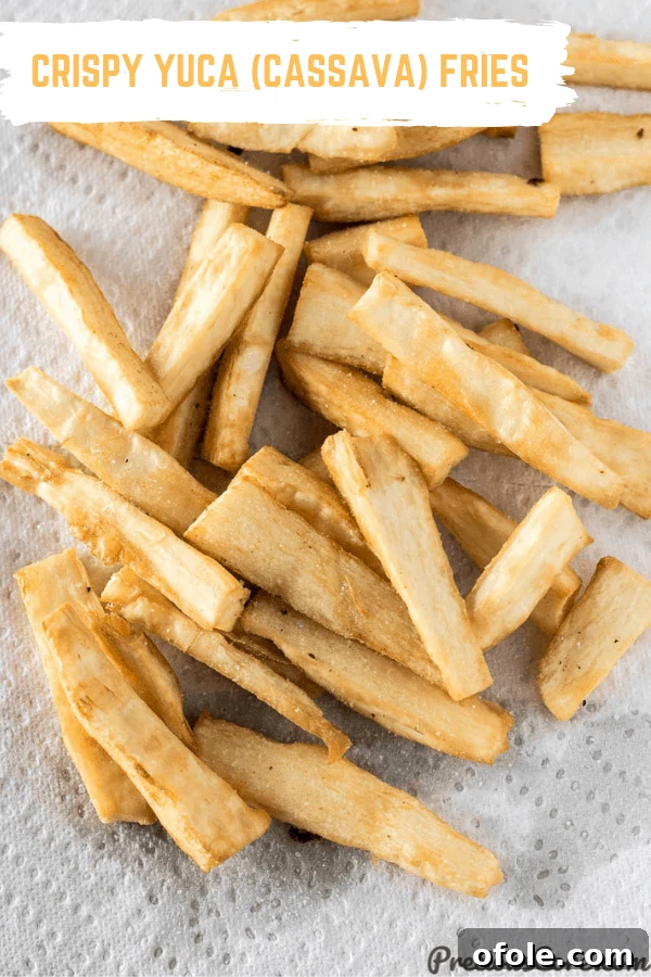 Irresistibly Crispy Yuca Fries 9 Delicious and perfectly fried Yuca Fries on paper towels, ready for serving.