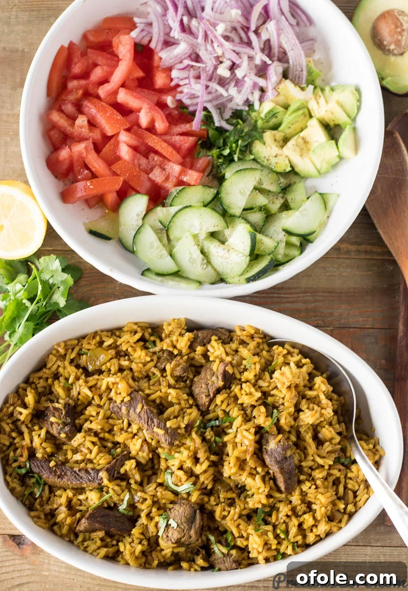 Bowl of Beef Pilau next to a bowl of vegetables.