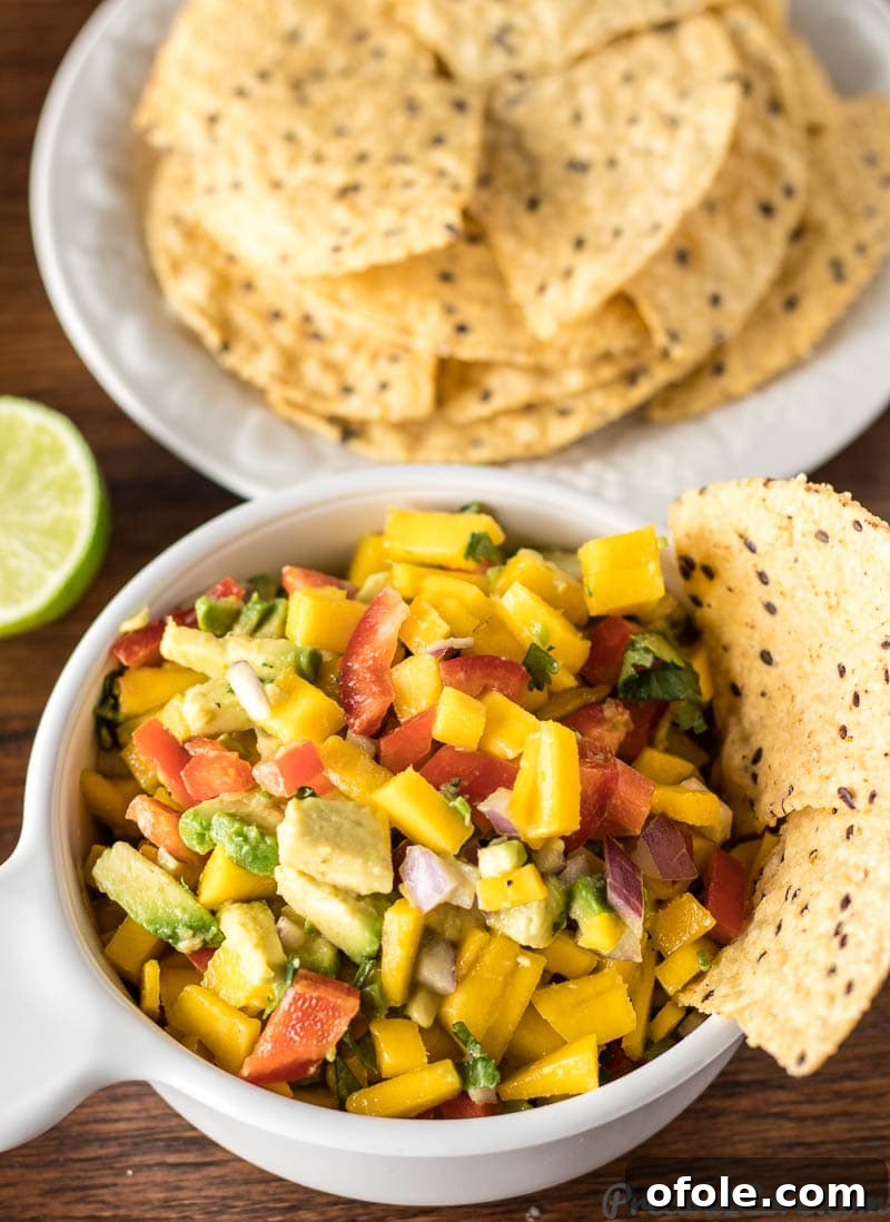 Homemade mango avocado salsa served with tortilla chips.