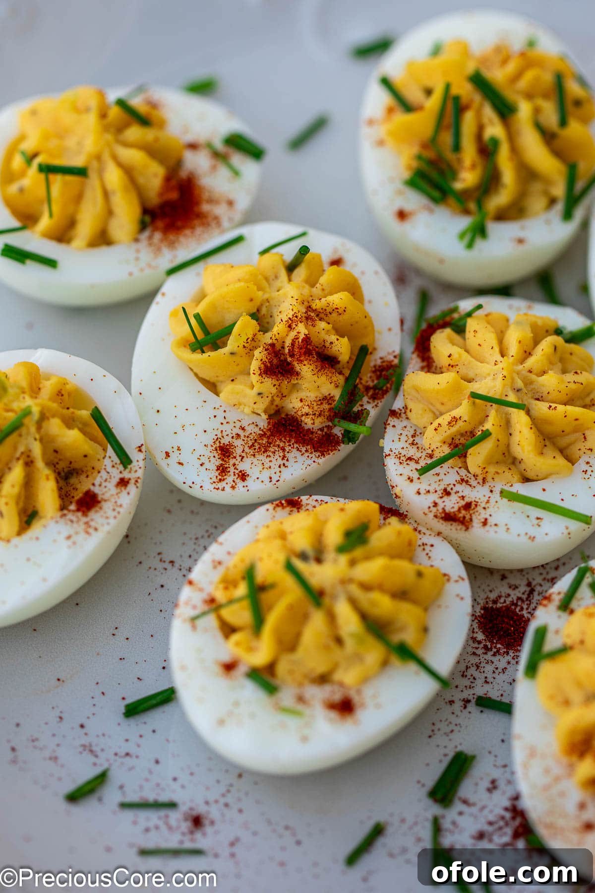 Southern Charm Deviled Eggs 12 Deviled eggs with various toppings including paprika and herbs.