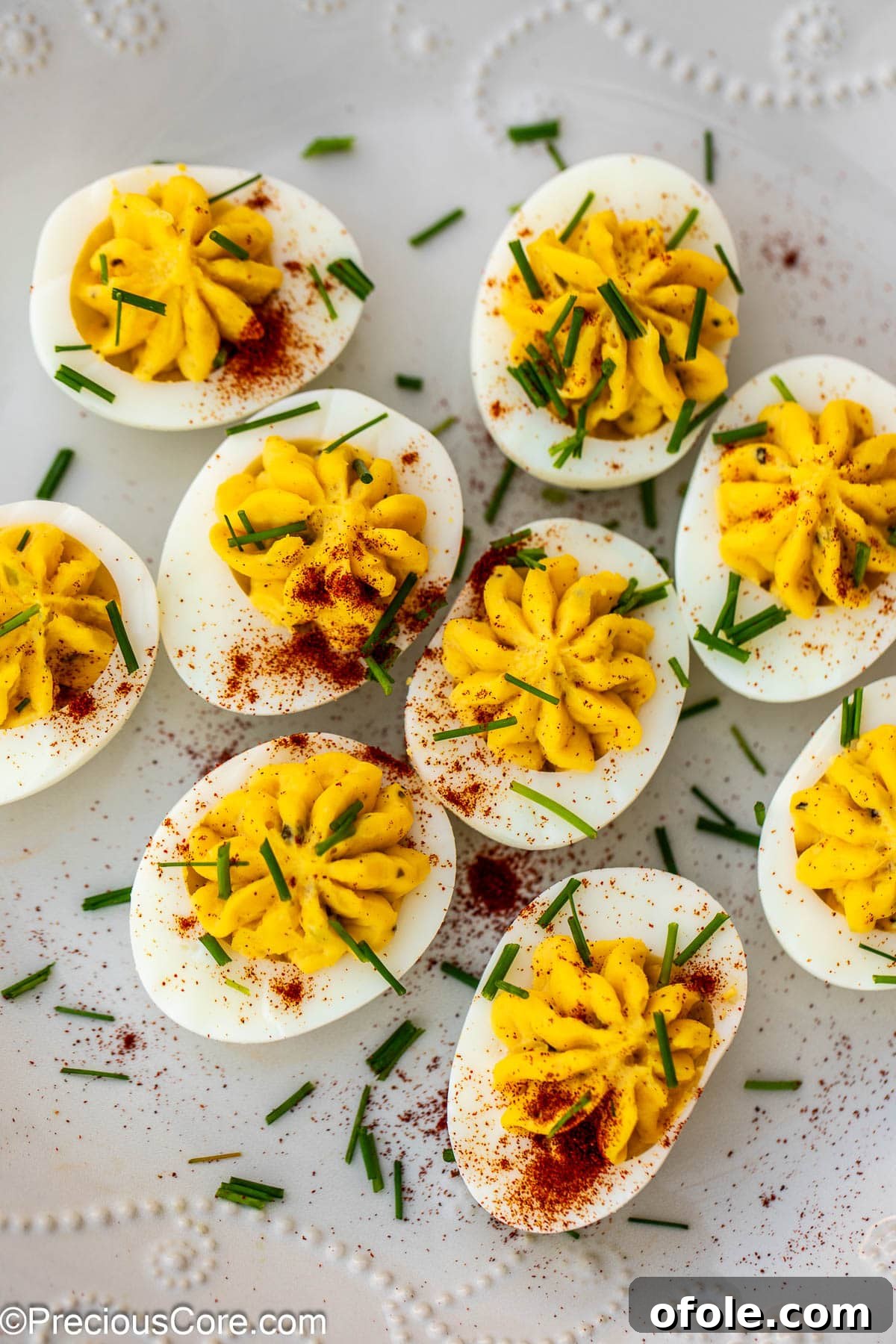 Southern Charm Deviled Eggs 13 Deviled eggs garnished with paprika and fresh herbs for presentation.
