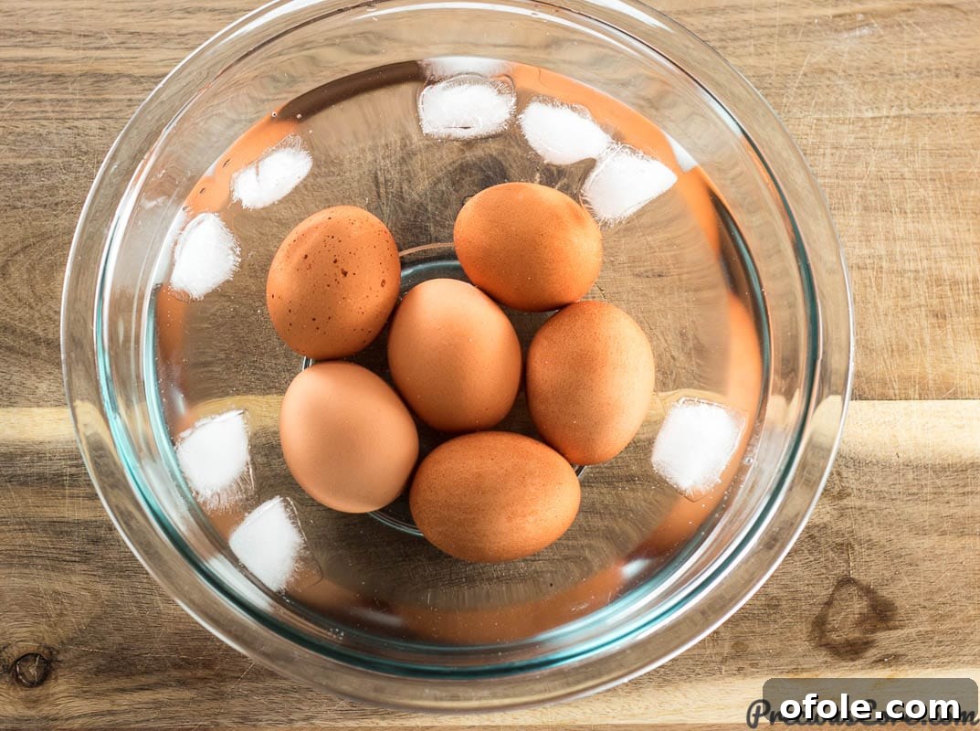Southern Charm Deviled Eggs 5 Hard-boiled eggs cooling in an ice bath.