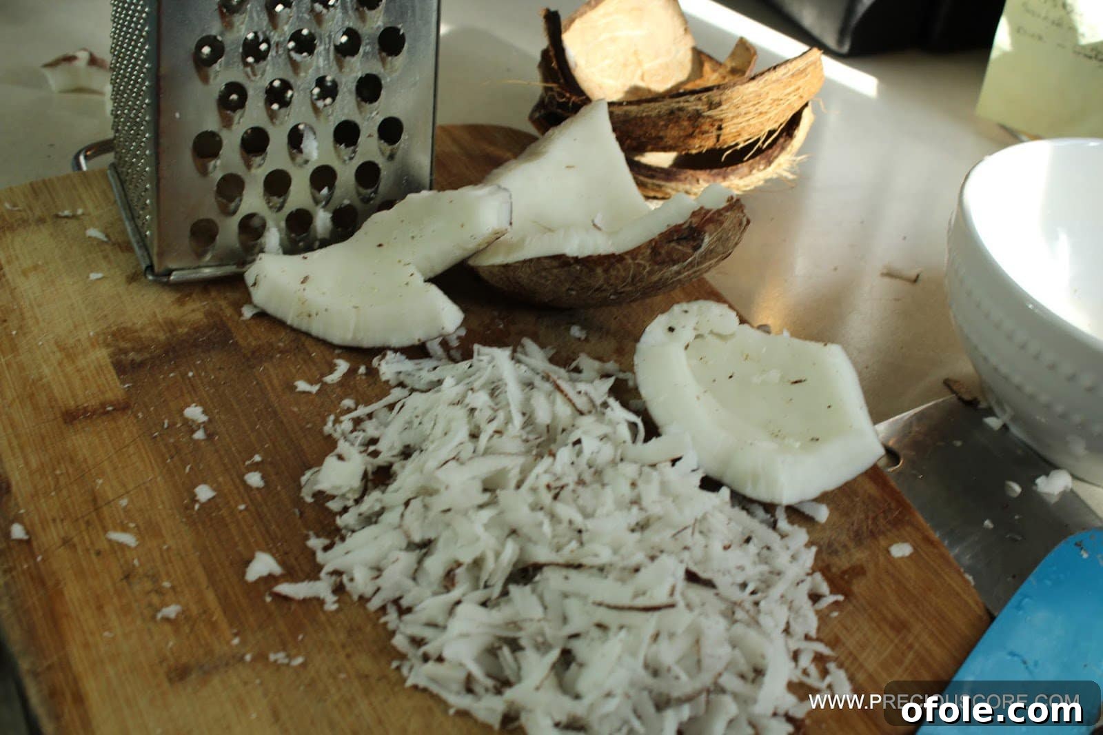 Shredding fresh coconut with a grater