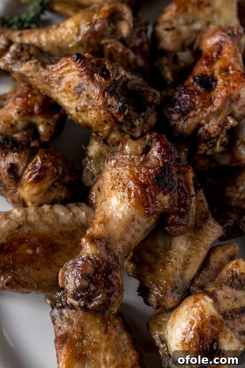 Perfectly cooked Jerk Chicken Wings, golden-brown and glistening with marinade, served on a platter