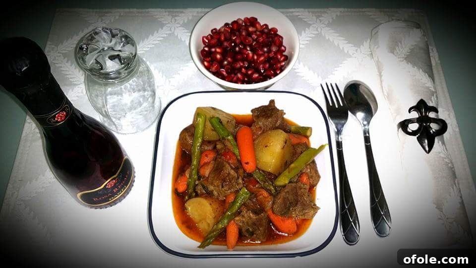 A close-up shot of a richly prepared Cameroonian dish, likely with meat and vegetables