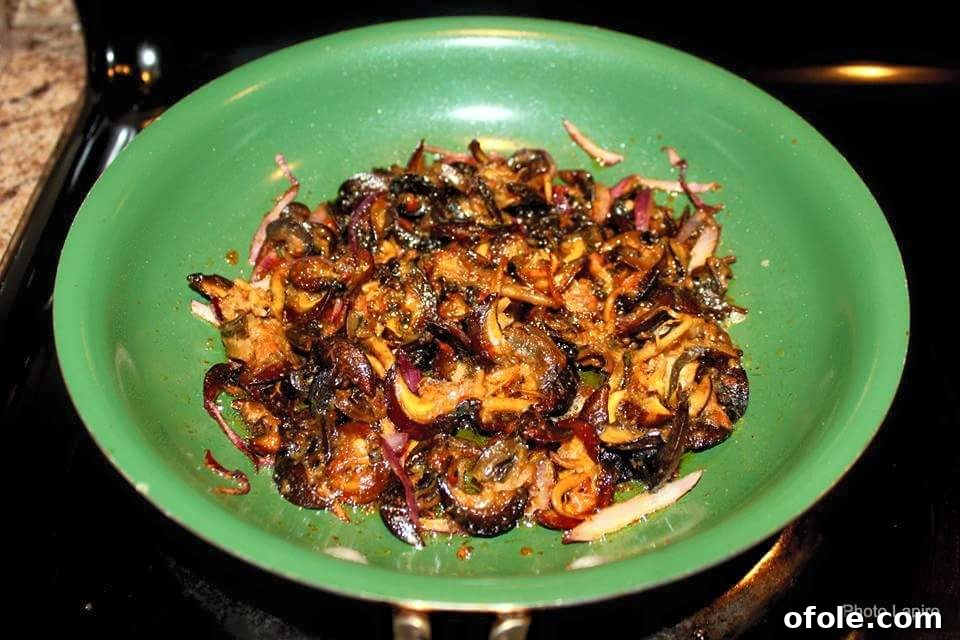 A dish featuring cooked snails, nyamangoro (possibly a local vegetable), and congo meat, showcasing traditional Cameroonian ingredients
