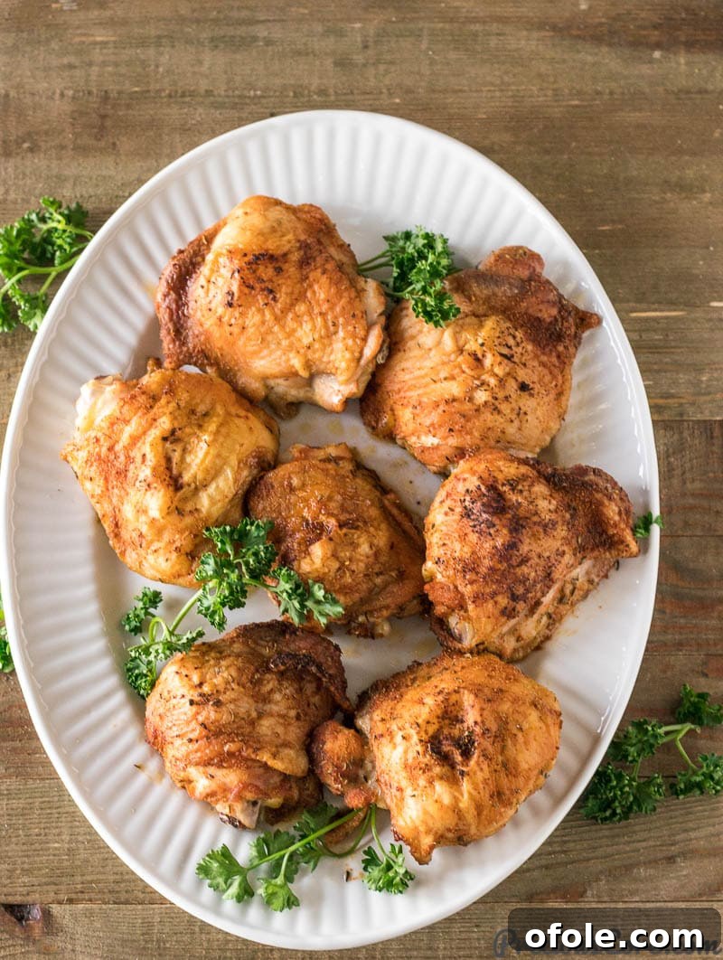 Golden Crispy Oven Chicken Thighs 2 Baked Chicken Thighs on a platter