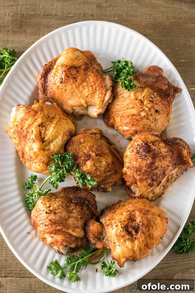 Golden Crispy Oven Chicken Thighs 6 Crispy baked chicken thighs on a serving tray