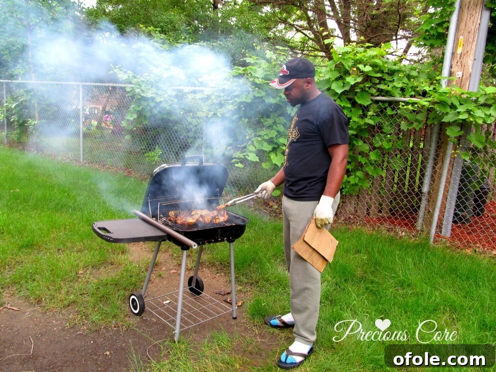 The Grill Master at Work My partner, Mr. N, expertly tending to the charcoal grill, flipping chicken