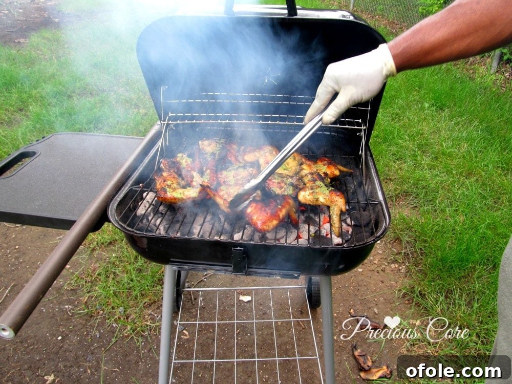 Close-up of perfectly grilled chicken wings and thighs with a beautiful char