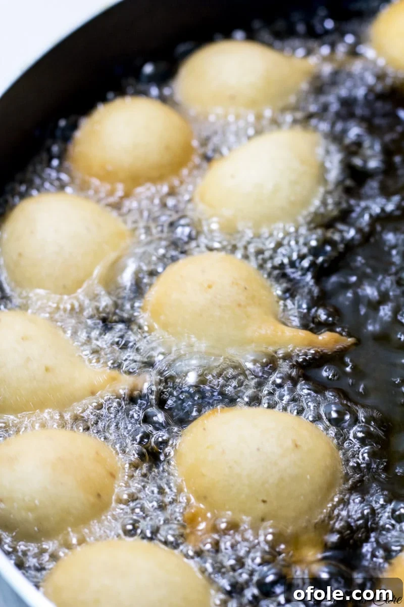 Frying cameroon doughnuts in hot oil.