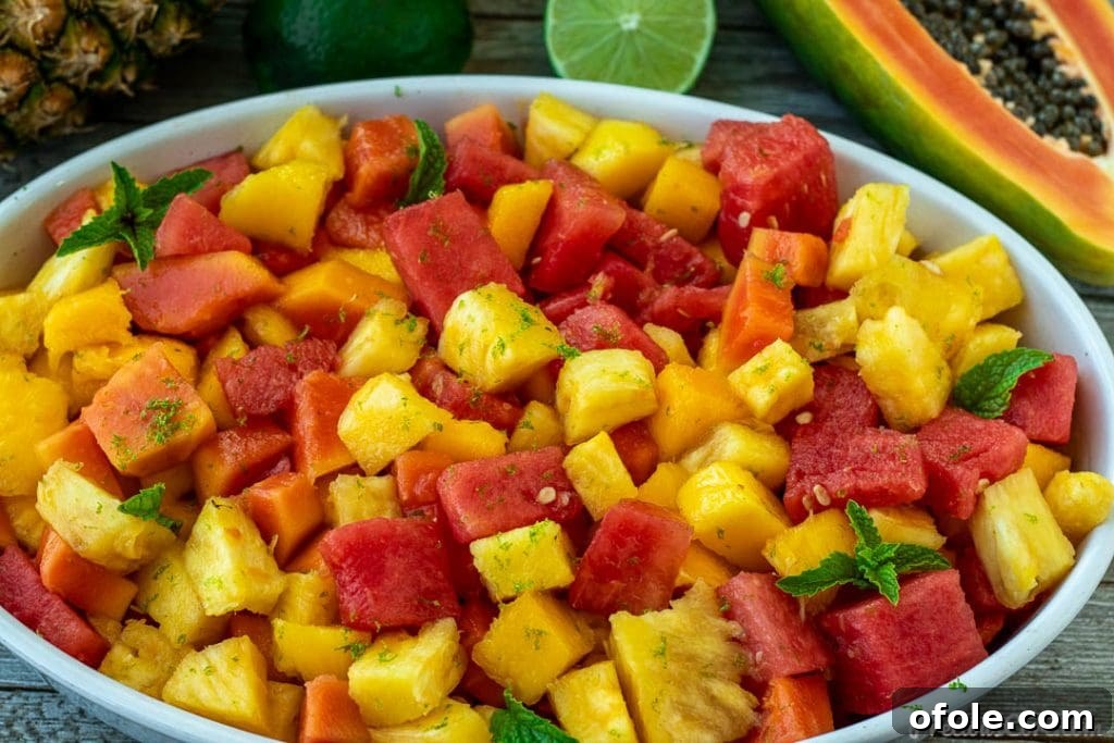 Generous Serving of Tropical Fruit Salad A wide, landscape view of a large bowl filled with colorful tropical fruit salad, perfectly illustrating its freshness and appeal.