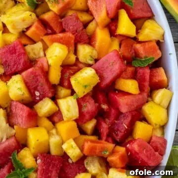 Tropical fruit salad in a serving bowl.
