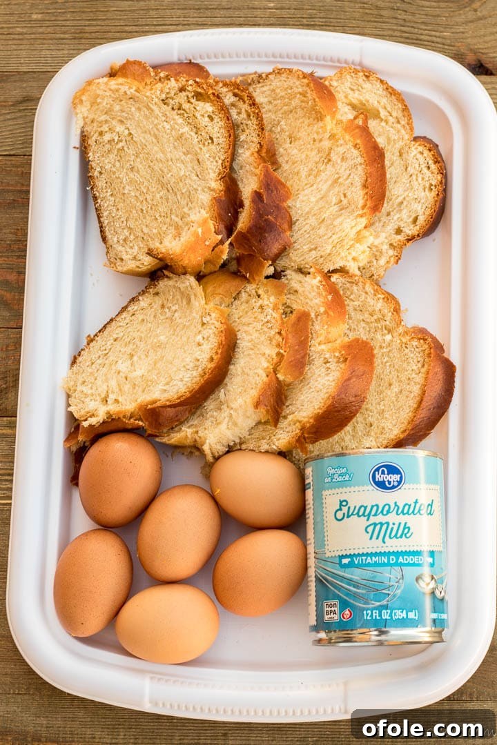 Golden Challah Bread Pudding 3 Picture of challah bread slices, fresh eggs, and a can of evaporated milk, ready for the recipe