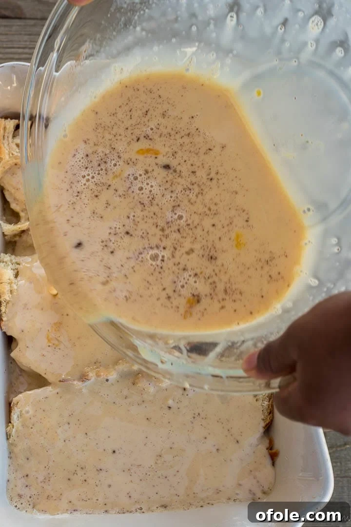 Golden Challah Bread Pudding 7 Pouring the liquid egg custard mixture over the Challah bread in the baking pan