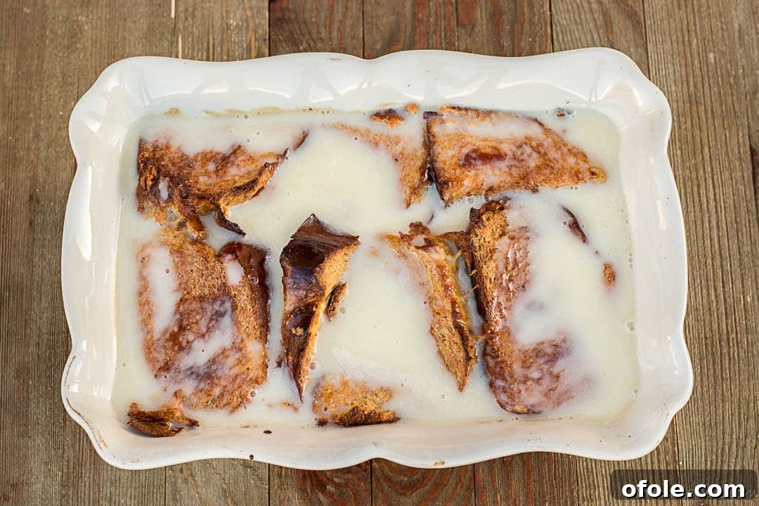 Golden Challah Bread Pudding 10 Baked Challah Bread Pudding with a generous amount of bread pudding sauce poured over it