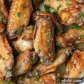 Garlic Butter Wings in a white dish, glossy and ready to serve.