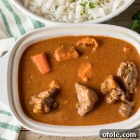 Bowl of African Peanut Stew (Mafe), a rich and comforting dish.