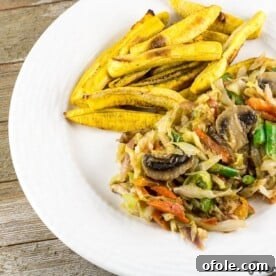 Cameroonian Cabbage Stew served with baked plantain fries, a colorful vegetarian dish.