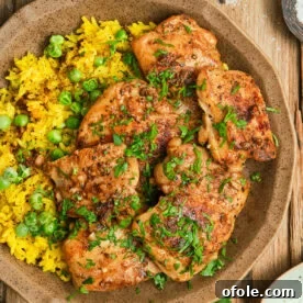 Pan Seared Boneless Chicken Thighs served with yellow rice, a quick and flavorful chicken dinner.