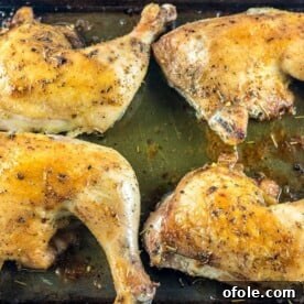 Baked Chicken Leg Quarters on a baking tray, golden brown and perfectly seasoned.