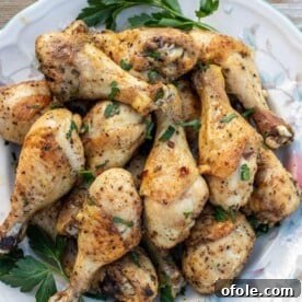 Baked Chicken Drumsticks on a serving platter, golden brown and crispy.