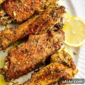 Lemon pepper turkey wings on a serving platter, golden and perfectly seasoned.