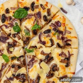 Pizza topped with mushrooms and fresh basil, a simple and tasty homemade pizza.